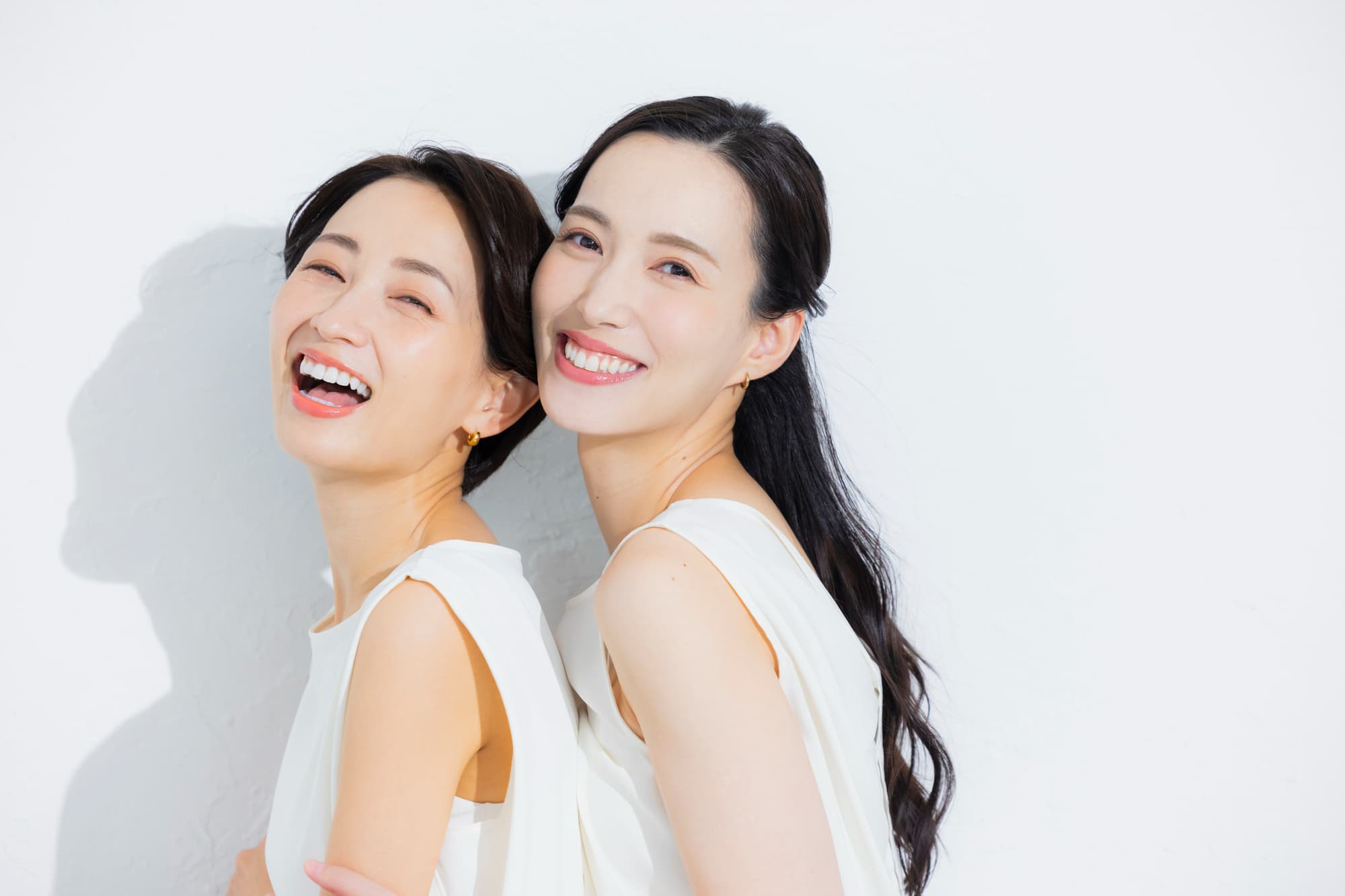 白い歯を見せて笑う二人組の女性